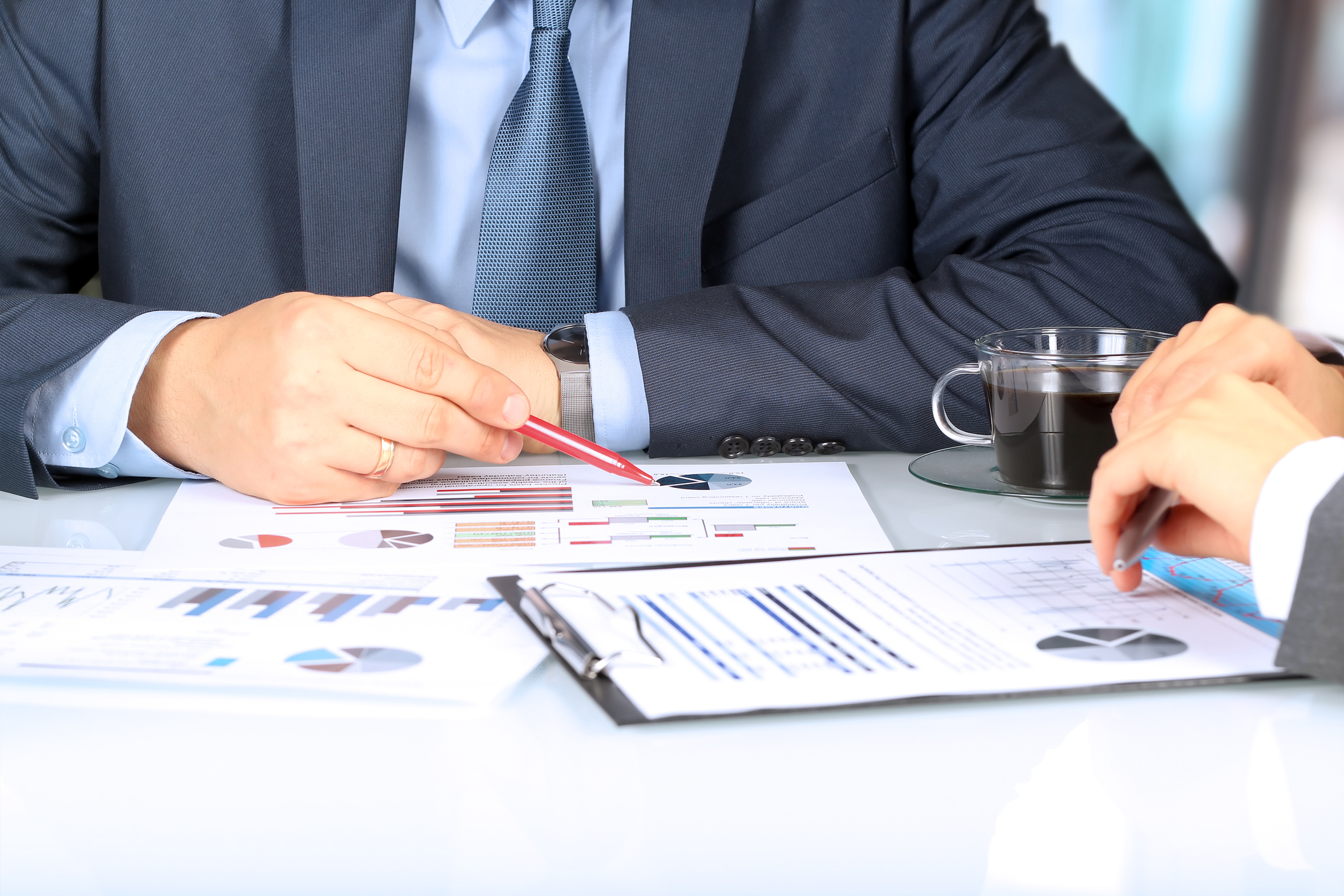 business colleagues working together and analyzing financial figures on a graphs